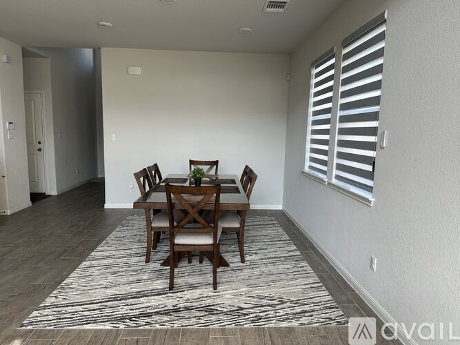 A dining room with a table set for four.