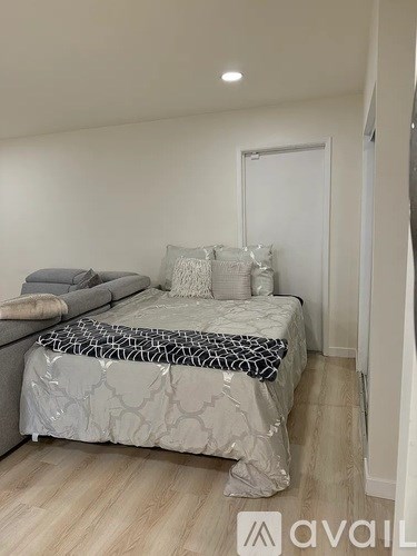 A bedroom with a bed and a couch.