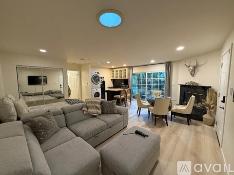 A living room with a grey sofa and a television.