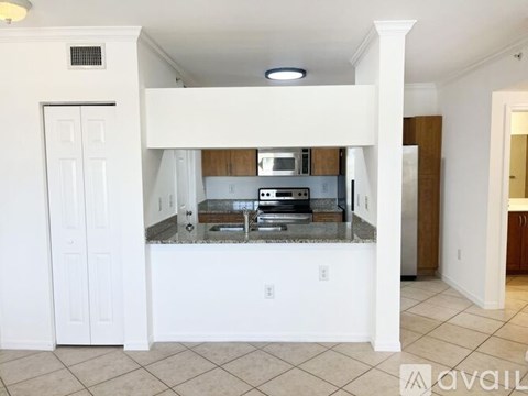 A kitchen with white cabinets and a countertop.
