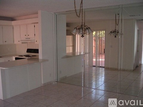A kitchen with white cabinets and a glass door.