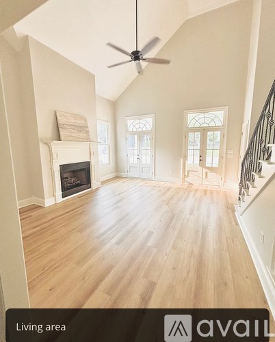 A living area with a fireplace and a fan.