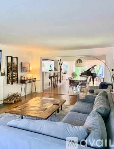 A living room with a grey sofa and a wooden coffee table.