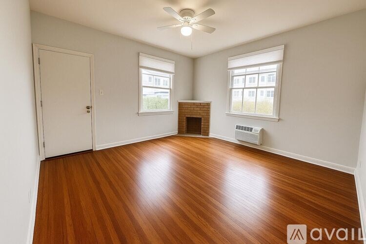 A room with wooden floors and a fireplace.
