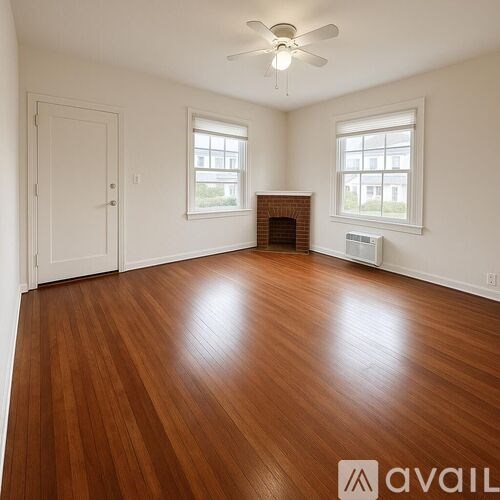 A room with a fireplace and a fan on the ceiling.