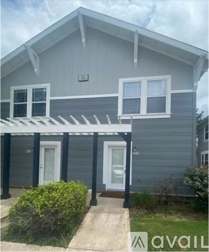 A house with a grey exterior and a white door.