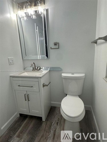 A white toilet sits next to a sink in a bathroom.