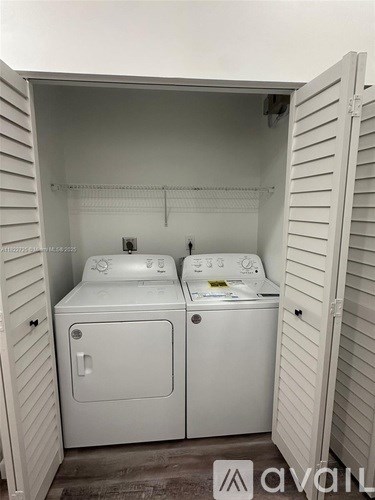 A small laundry room with a washer and dryer.