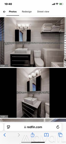 A bathroom with a sink, toilet, and mirror.