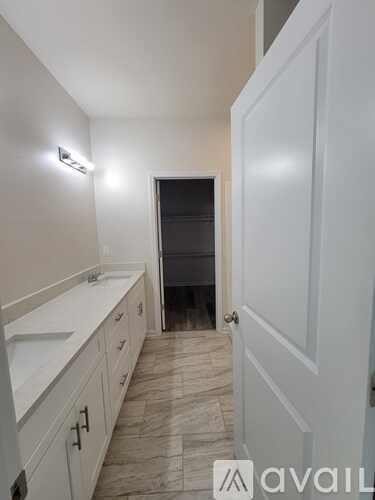 A bathroom with a sink and a door.