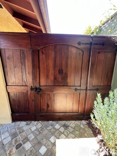 A wooden door with a metal handle and a latch.