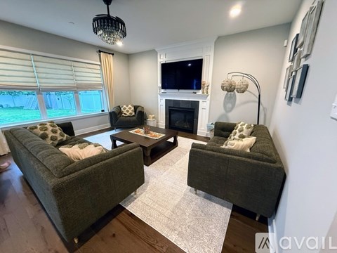 A living room with two grey couches and a television.