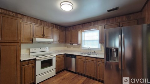 A kitchen with wooden cabinets and stainless steel appliances.
