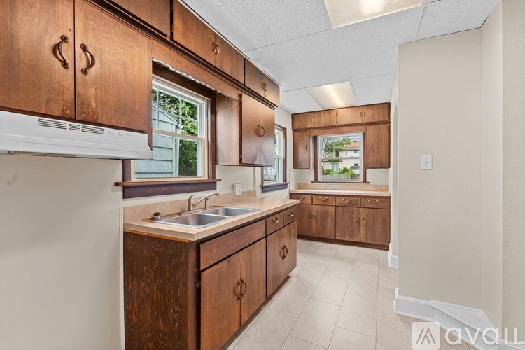 A kitchen with wooden cabinets and a white countertop.