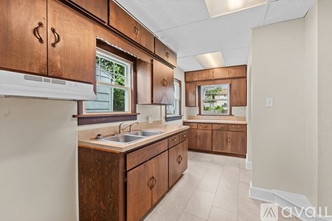 A kitchen with wooden cabinets and a white countertop.