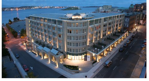 A large building with a lot of windows is lit up at night.