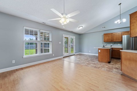 A kitchen with wooden cabinets and a ceiling fan.