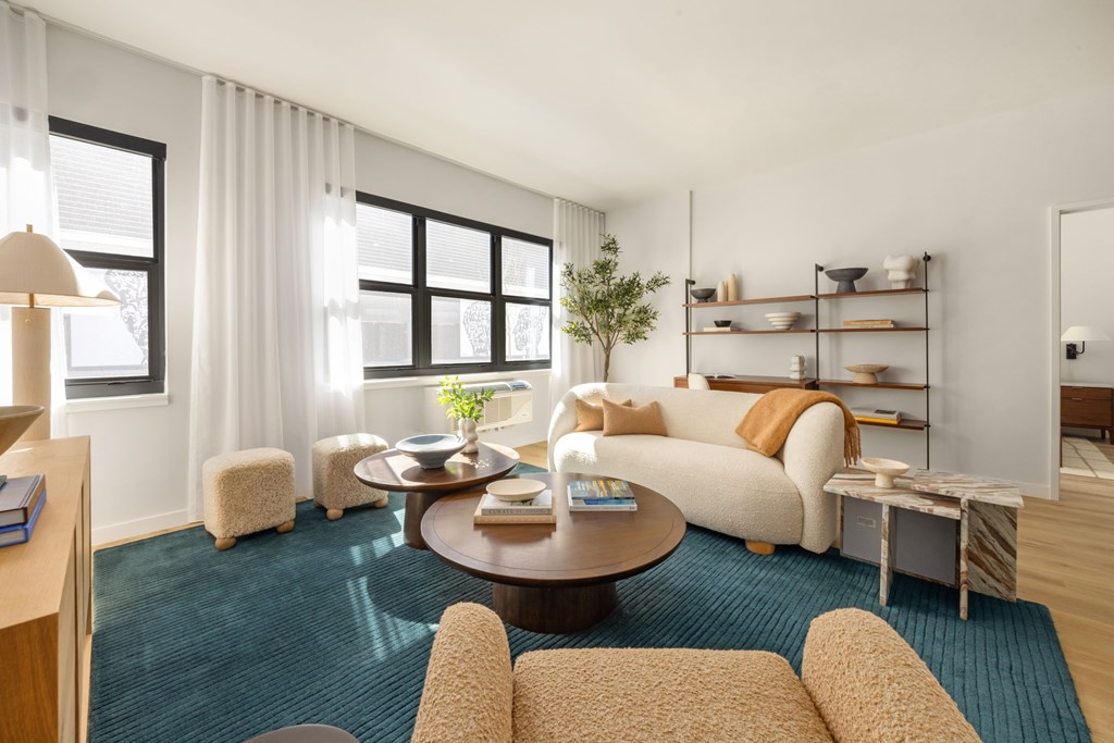 A living room with a couch, a table, and a lamp.