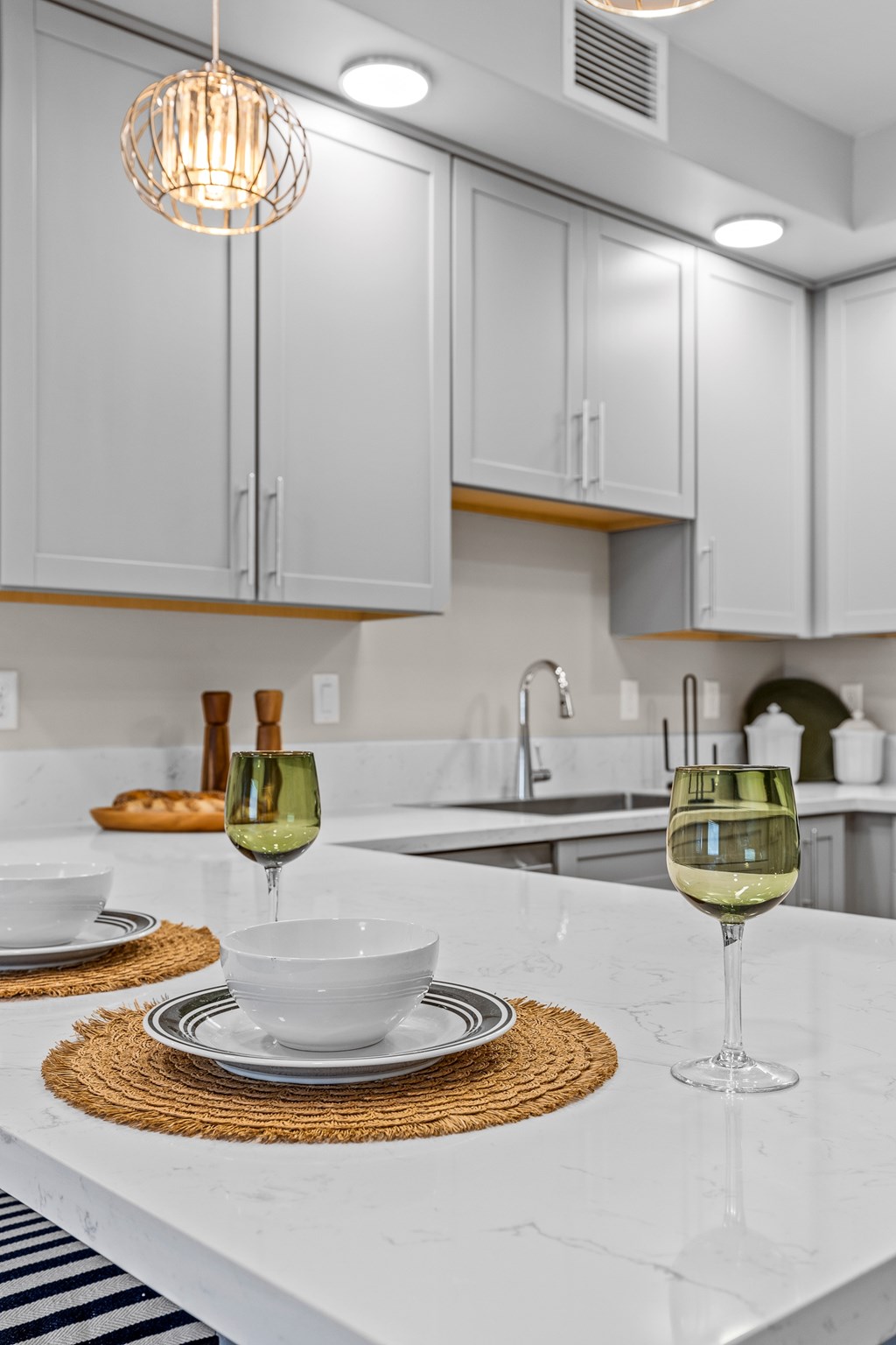 A kitchen with a white counter top and a white cabinet.