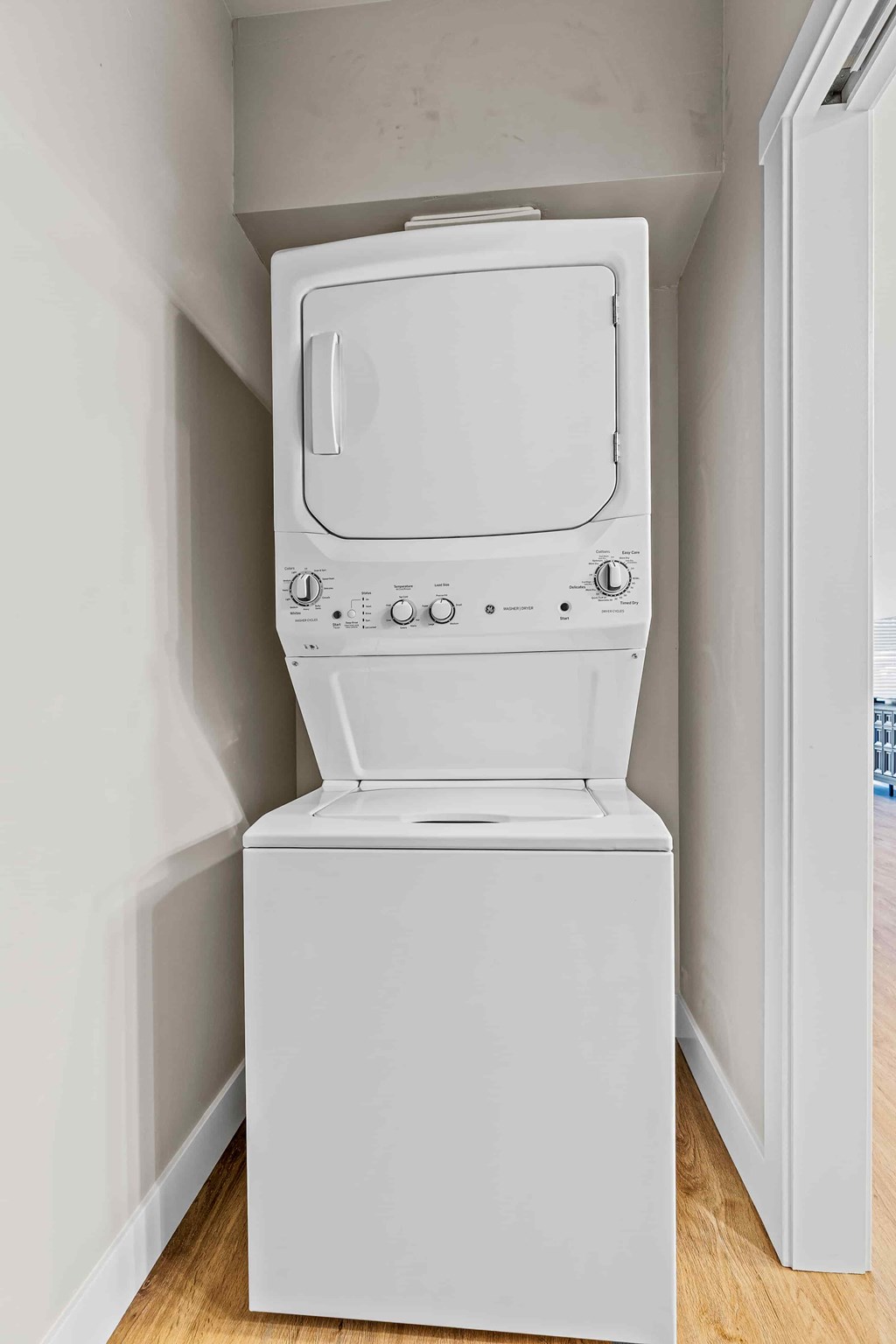 A white washing machine in a small room.