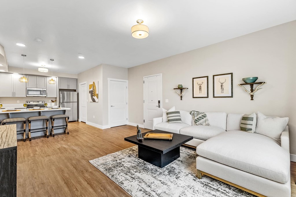 A modern living room with a white couch and a black coffee table.