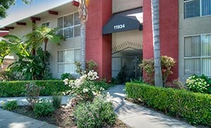 A red and white building with a black awning that says 11934.