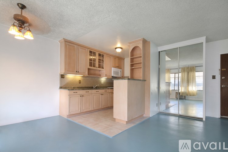 A kitchen with wooden cabinets and a countertop is shown.