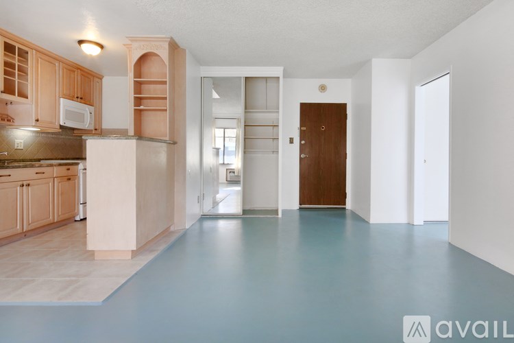 A kitchen with wooden cabinets and a white refrigerator.