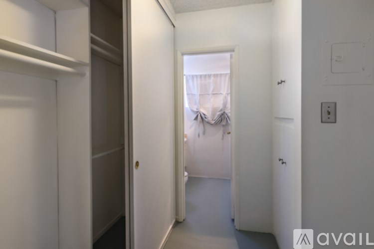 A white bathtub with a pink tiled wall behind it.