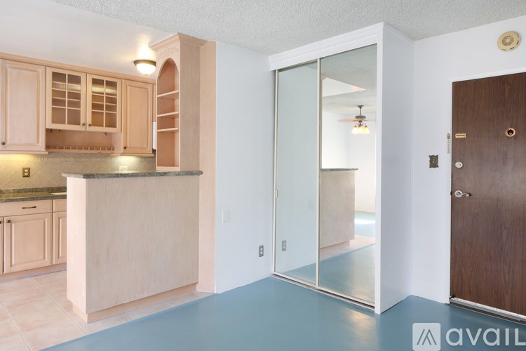 A kitchen with wooden cabinets and a counter top.