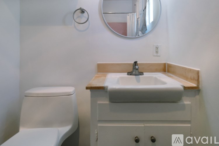 A white toilet sits next to a sink in a bathroom.