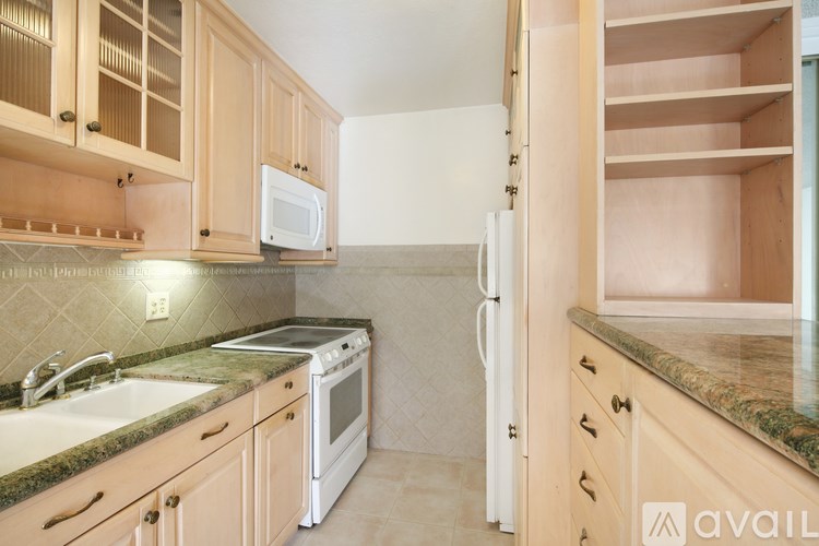 A kitchen with wooden cabinets and a white refrigerator.