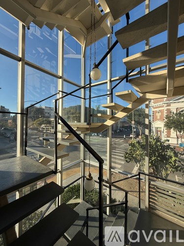A spiral staircase with a hanging light fixture.