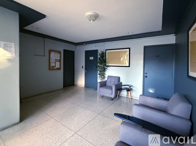 A spacious waiting room with a Christmas tree and comfortable seating.