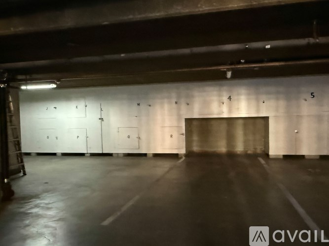 A large, empty warehouse with numbered doors.