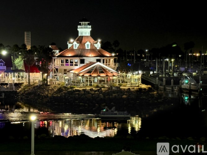 A building with a tower is lit up at night.