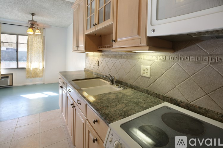 A kitchen with wooden cabinets and a granite countertop.