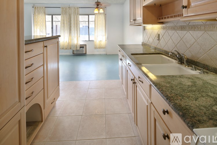 A kitchen with wooden cabinets and a granite countertop.
