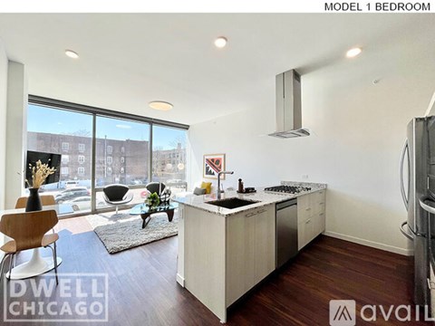 A modern kitchen with a dining table and chairs is available for rent.