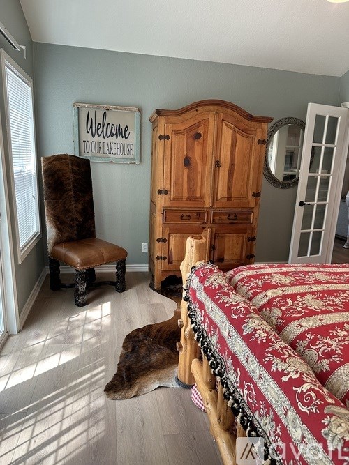 A dog is lying on the floor in a room with a wooden cabinet and a welcome sign on the wall.