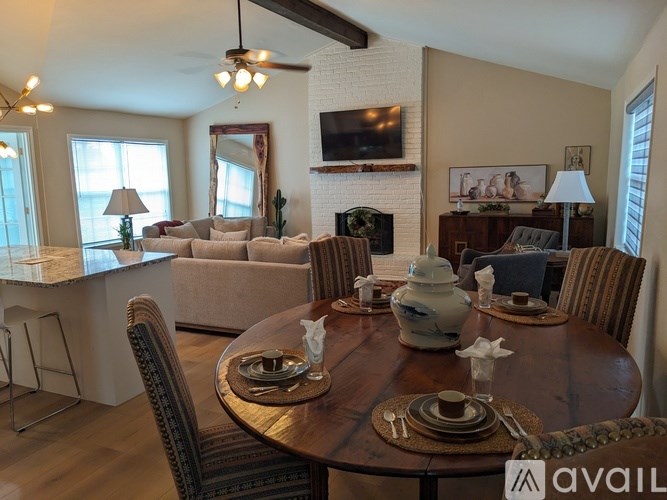 A dining room with a wooden table set for a meal.