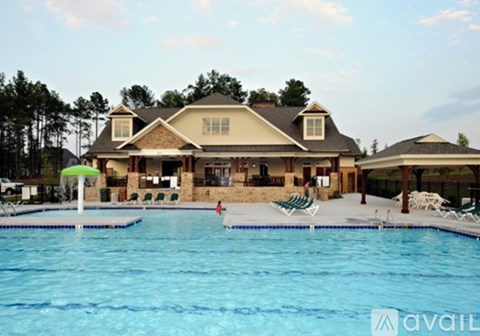 A house with a pool in front of it.