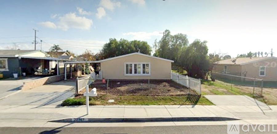 A house with a white fence and a sign that says "available" in front of it.