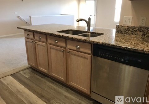 A kitchen with wooden cabinets and a granite countertop.