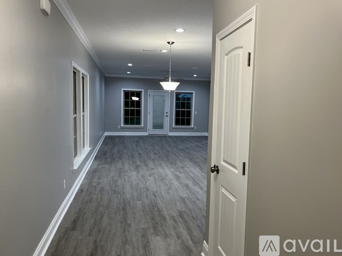 A room with grey flooring and white walls.
