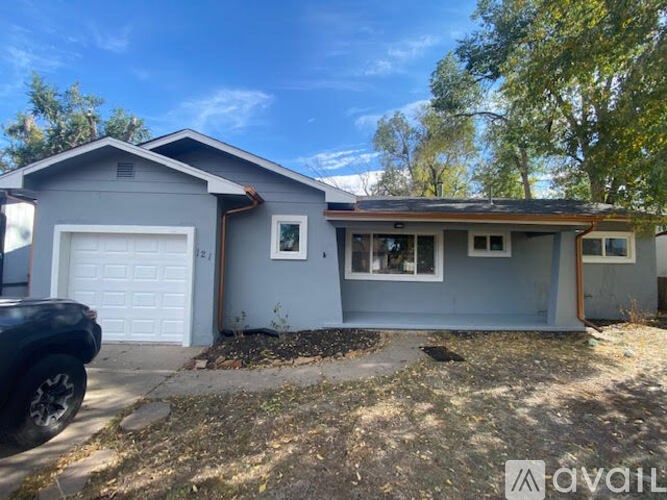 A house with a grey garage door is for sale.