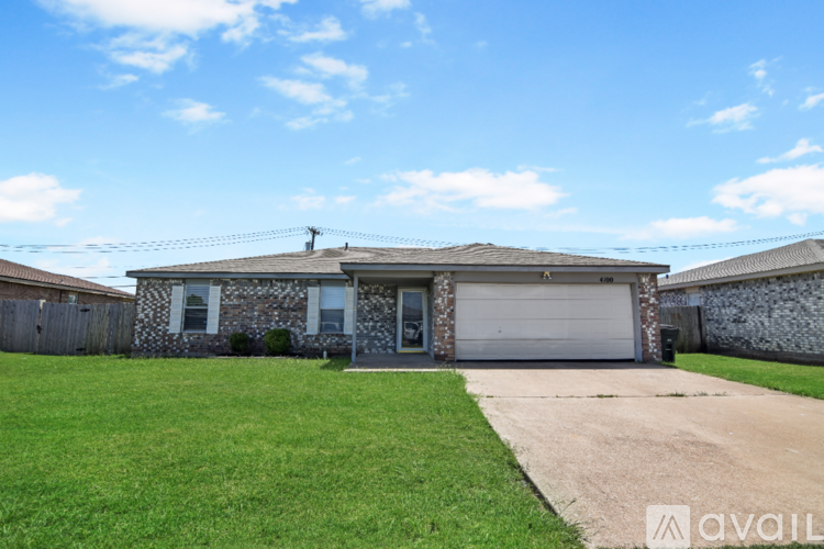 A house with a garage and a driveway in front.