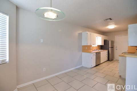 A kitchen with white cabinets and appliances.