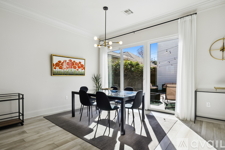 A dining room with a table set for four.