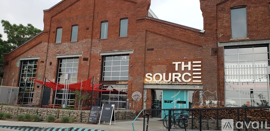 A building with a sign that says "The Source" on it.